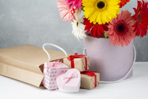 bucket with gerbera flowers gift papers boxes